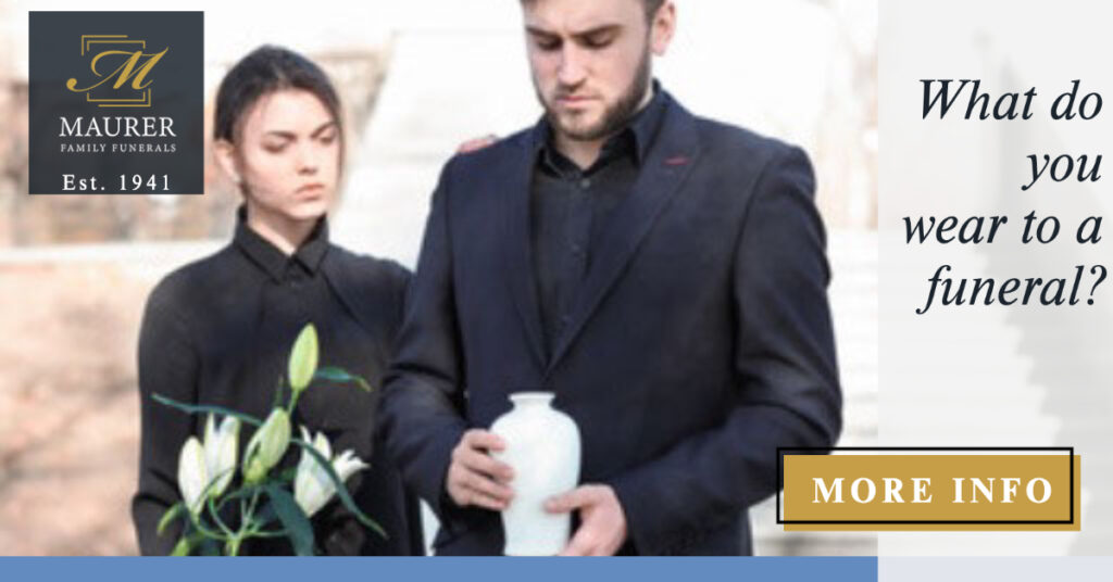 Mourners in dark formal clothing holding white flowers