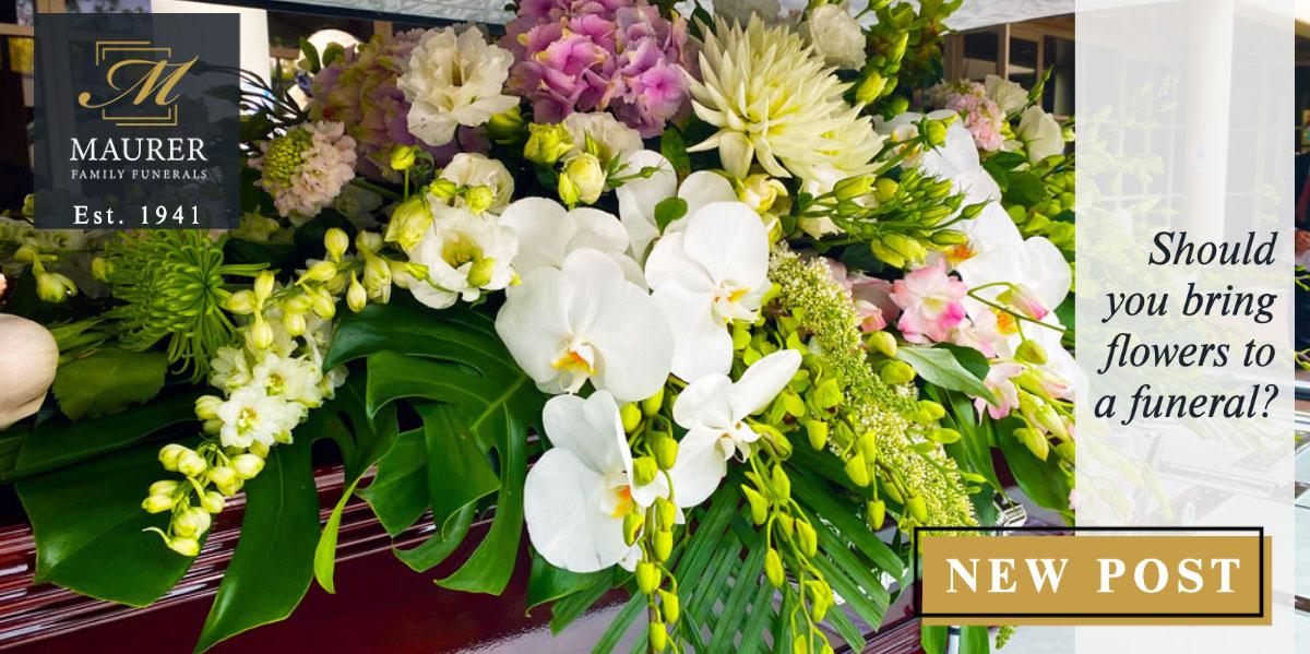 Funeral flower arrangement with white orchids and pink roses