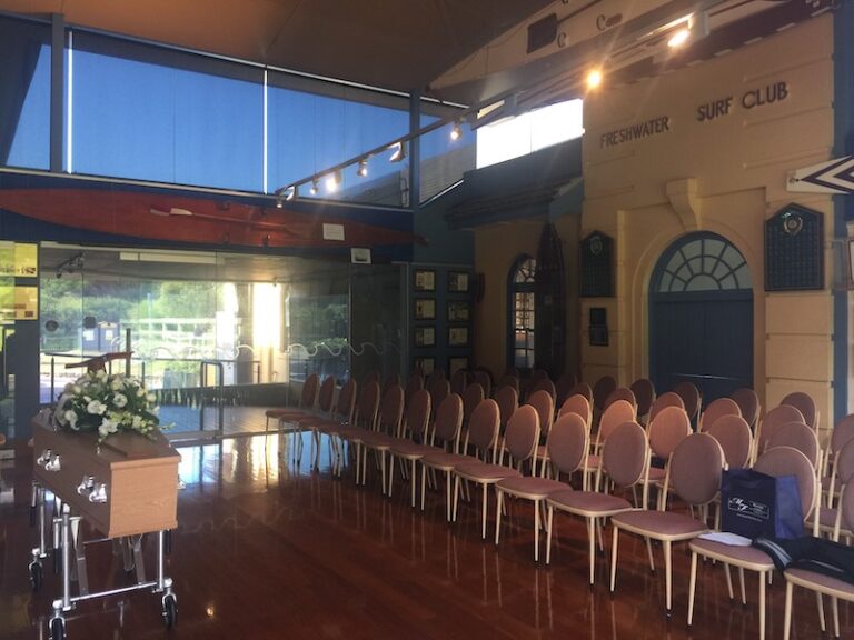Function room set up for a funeral service at a surf club
