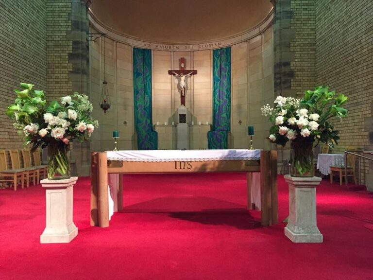 Maurer chapel with red carpet, flowers and a blue drape